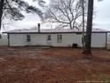 Exterior shot of the back of the home with a metal roof at 22176 Nc 24-27, Cameron, NC 28326