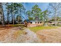 Charming brick home with a manicured lawn and inviting front porch at 3524 June Rd, Sanford, NC 27332