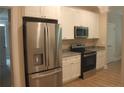 Well-equipped kitchen with white cabinets, stainless steel appliances, and granite countertops at 261 River Falls Rd, Sanford, NC 27332