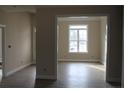 Well lit room with light colored walls and floors and a large window at 261 River Falls Rd, Sanford, NC 27332