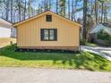 This home features new landscaping, green grass, and a modern exterior at 306 Harbor Trace, Sanford, NC 27332