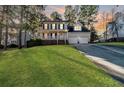 Charming two-story home featuring a bright green manicured lawn, attached two-car garage and welcoming front porch at 336 Richmond Park Dr Dr, Cameron, NC 28326