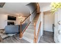 Inviting foyer featuring a staircase, views of the living room and fireplace, and wood-look flooring at 336 Richmond Park Dr Dr, Cameron, NC 28326