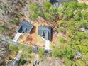 Aerial view of two gray homes with black roofs and wooded surroundings at 5115 Cardinal Cir, Sanford, NC 27332