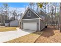 Spacious attached garage with white door, gray siding and driveway at 5115 Cardinal Cir, Sanford, NC 27332