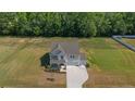 Aerial view of a two-story home with a well-maintained lawn and a two-car garage at 91 Walker Grove Ln, Lillington, NC 27546