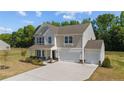 Beautiful two-story home with a two-car garage and a manicured lawn at 91 Walker Grove Ln, Lillington, NC 27546