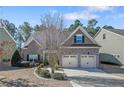 Charming two-story home with brick and stone accents, a two-car garage, and lush landscaping at 1031 Micah'S N Way, Spring Lake, NC 28390