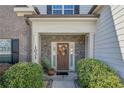 Inviting front entrance with stone accents, decorative wreath, and manicured shrubbery at 1031 Micah'S N Way, Spring Lake, NC 28390