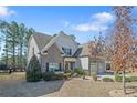 Beautiful home with a mix of stone and siding, complemented by a well-manicured lawn at 1031 Micah'S N Way, Spring Lake, NC 28390