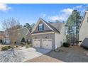 Side view of a home showing a two-car garage and well-maintained landscaping at 1031 Micah'S N Way, Spring Lake, NC 28390