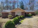 Quaint one-story brick home with mature landscaping in a wooded setting at 1134 Deerfoot Trl, Sanford, NC 27332