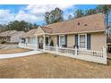 Inviting one-story home with a charming front porch, white picket fence, and manicured lawn at 2123 Detroit Blvd, Sanford, NC 27332