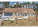 Charming one-story home featuring an attached garage and a manicured front yard with a walkway to the front door at 2123 Detroit Blvd, Sanford, NC 27332