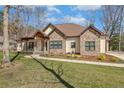 Beautifully landscaped front yard and covered porch accent this stone and siding home at 26 Traceway, Sanford, NC 27332