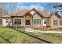 Charming stone and siding home with a manicured lawn and covered front porch at 26 Traceway, Sanford, NC 27332