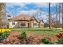 Beautifully landscaped front yard and covered porch accent this stone and siding home at 26 Traceway, Sanford, NC 27332