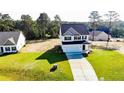 A beautiful home with a spacious lawn and long driveway under a sunny sky at 30 Blackgum Ct, Spring Lake, NC 28390