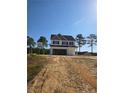 Charming two-story home featuring black shutters, a covered entryway, and an attached two car garage at 30 Blackgum Ct, Spring Lake, NC 28390