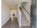 The foyer features durable flooring, a staircase, and a view into the living area at 30 Blackgum Ct, Spring Lake, NC 28390
