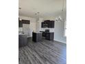Modern kitchen featuring a center island, dark cabinets, and stainless steel appliances at 30 Blackgum Ct, Spring Lake, NC 28390