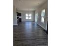 Spacious living room featuring hardwood floors, sliding glass door and view into the kitchen at 30 Blackgum Ct, Spring Lake, NC 28390