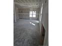 Spacious living room featuring sheetrock walls, concrete floors, and an abundance of natural light at 30 Blackgum Ct, Spring Lake, NC 28390