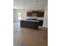 New kitchen features dark cabinetry, stainless steel appliances, and a convenient kitchen island at 52 Blackgum Ct, Spring Lake, NC 28390