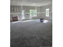 Unfinished living room with windows, a door to the outside, and bare concrete floor at 52 Blackgum Ct, Spring Lake, NC 28390
