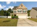 Charming two-story home with a manicured lawn, inviting entrance, and an attached two-car garage at 37 Taplow Trl, Cameron, NC 28326