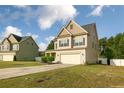 Two-story home with an inviting entrance, attached two-car garage and a well-manicured lawn at 37 Taplow Trl, Cameron, NC 28326