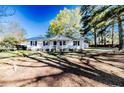 Inviting single-story home with a cozy front porch, complemented by the lush green yard at 488 Hall Rd, Erwin, NC 28339