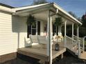 Inviting front porch featuring a swing, rocking chairs, and hanging ferns at 146 E Cool Springs E Rd, Lillington, NC 27546