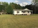 Charming single-story home with a well-maintained front yard and pink front door at 146 E Cool Springs E Rd, Lillington, NC 27546