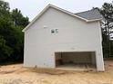 Spacious unfinished two-car garage with ample room for vehicles and storage, light gray exterior at 1945 Cranes Creek Rd, Cameron, NC 28326