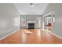 Sun-drenched living room features fireplace, wood floors, and open layout at 346 Northview Dr, Sanford, NC 27332
