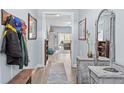 Inviting entryway with light blue walls, wooden floors, and stylish decorative furnishings at 405 Turriff Way, Cameron, NC 28326