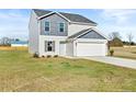 Attractive two-story home boasting gray siding, an attached two-car garage, and a cozy front yard at 41 Aldermann (Lot 2) Ct, Dunn, NC 28334