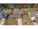Aerial view of a suburban home with a large backyard featuring a swimming pool and various recreational amenities at 480 N Prince Henry Way, Cameron, NC 28326