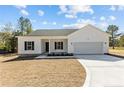 New home displaying a manicured lawn, white siding, black shutters, and attached two car garage at 4955 Ray Rd, Spring Lake, NC 28390