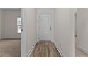 Inviting entryway featuring luxury vinyl plank flooring, crisp white trim and neutral paint at 4955 Ray Rd, Spring Lake, NC 28390
