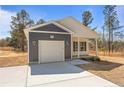 A cozy single-story home with a gray and white exterior and an attached one-car garage at 5011 Ray Rd, Spring Lake, NC 28390