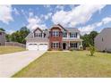 Charming two-story home with a well-maintained lawn and a spacious two car attached garage at 519 Wood Point Dr, Lillington, NC 27546
