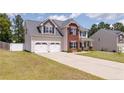 Charming two-story home with a well-maintained lawn and a spacious two car attached garage at 519 Wood Point Dr, Lillington, NC 27546
