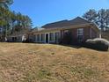 A spacious backyard featuring a large sunroom, offering plenty of room for outdoor activities at 561 Anderson Creek Dr, Spring Lake, NC 28390