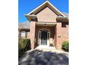 Charming front porch with a seating area, complemented by brick accents and a well-maintained lawn at 561 Anderson Creek Dr, Spring Lake, NC 28390