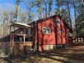 Side view of home with large deck, windows, and metal roof at 972 High Harbor Rd, Sanford, NC 27332