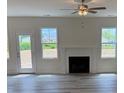 Bright living room features a fireplace and multiple windows for natural light at 161 Jones Creek Ln, Lillington, NC 27546
