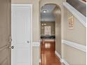 Elegant foyer featuring hardwood floors, arched doorway, and a glimpse into the living spaces at 178 Tun Tavern Dr, Cameron, NC 28326