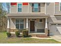 Inviting front porch with brick accents and decorative columns, perfect for enjoying the outdoors at 178 Tun Tavern Dr, Cameron, NC 28326